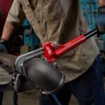 a man holding a pipe wrenches