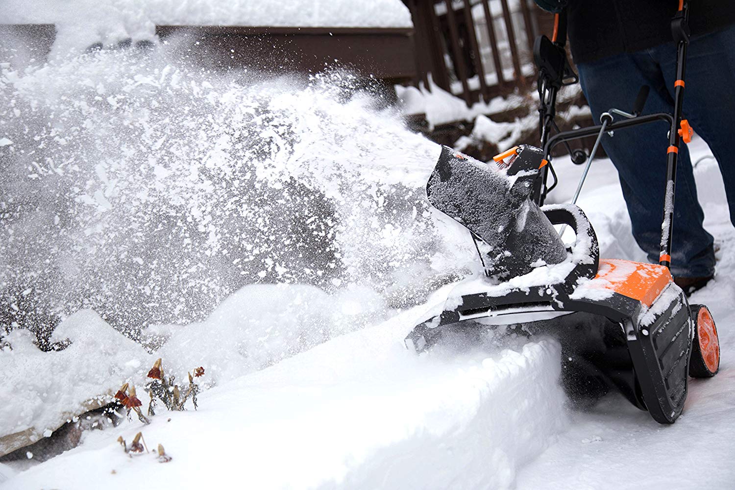 man with cordless snow blowers