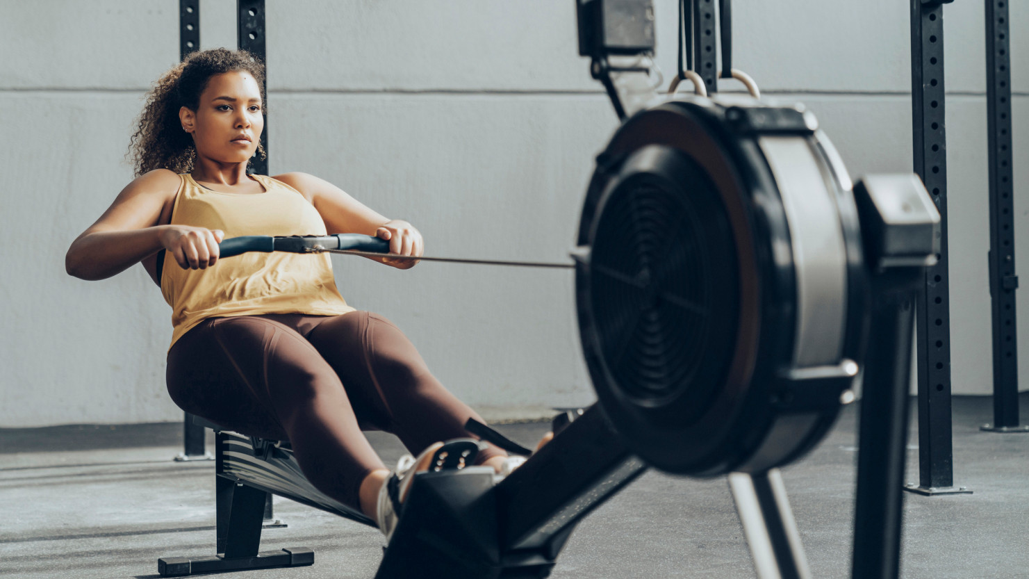 a woman on a rowing machine in a weight loss tool