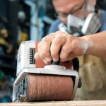 carpenter-working-belt-sander-polishing